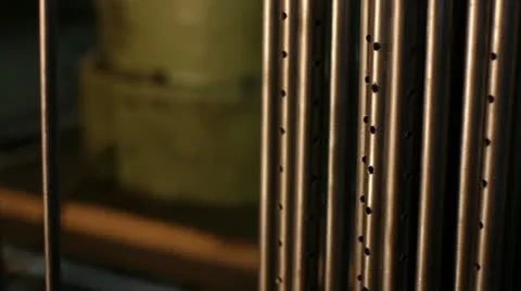 The hand of worker puts a metallic pipe at the plant Stockbeeldmateriaal 11339399