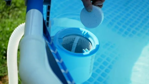 Hand of the worker puts white tablets into pool skimmer Stock Footage 156893971