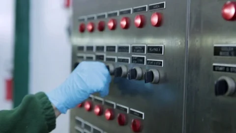 Hand of worker turning knobs on control panel Stock Footage 79506732
