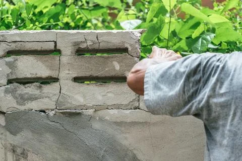 Hand of worker using hammer smashing and demolish on brick wall at construc.. Stock Photos