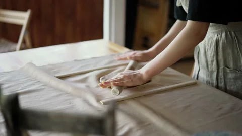 Hand working with clay using a rolling pin Stock Footage 209863992