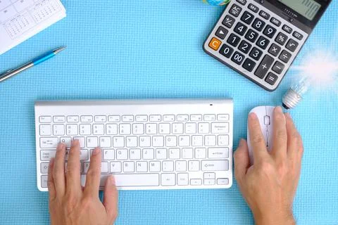 Hand working computer on table top view on working space with office equipmen Stock Photos