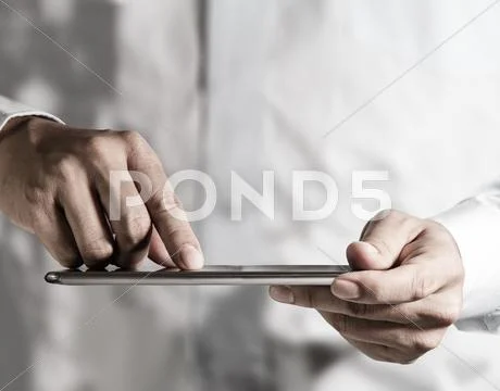 Hand working on a digital tablet Stock Illustration
