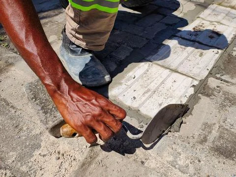 Hand working on floor installation. Stock Photos