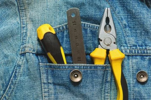 Hand working tools in jeans jacket pocket Stock Photos