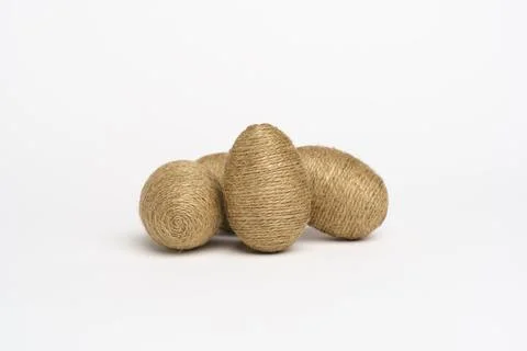 Hand wrapped easter eggs with jute twine, isolated white background. Stock Photos