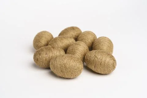 Hand wrapped easter eggs with jute twine, isolated white background. Stock Photos