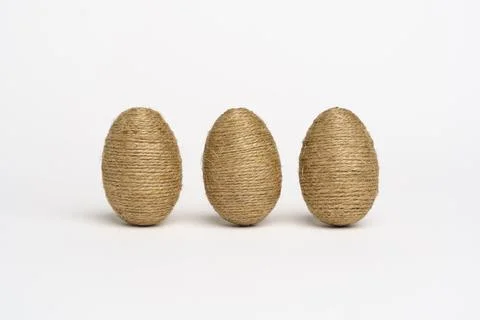 Hand wrapped easter eggs with jute twine, isolated white background. Stock Photos