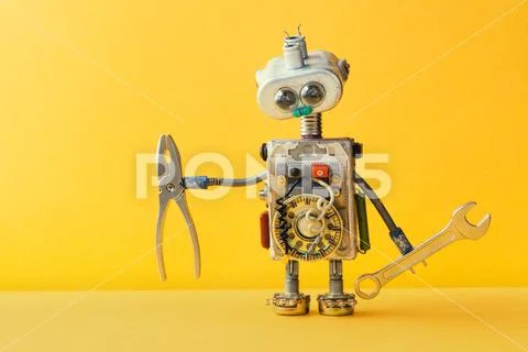 Hand wrench pliers robot handyman on yellow background. Cyborg toy lamp bulb Stock Photos