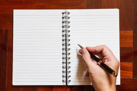 Hand write on notebook with pen. Stock Photos
