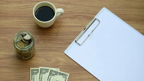Hand write word "finance" on clipboard with money and coffee. Financial planning Stockbeeldmateriaal 80907613