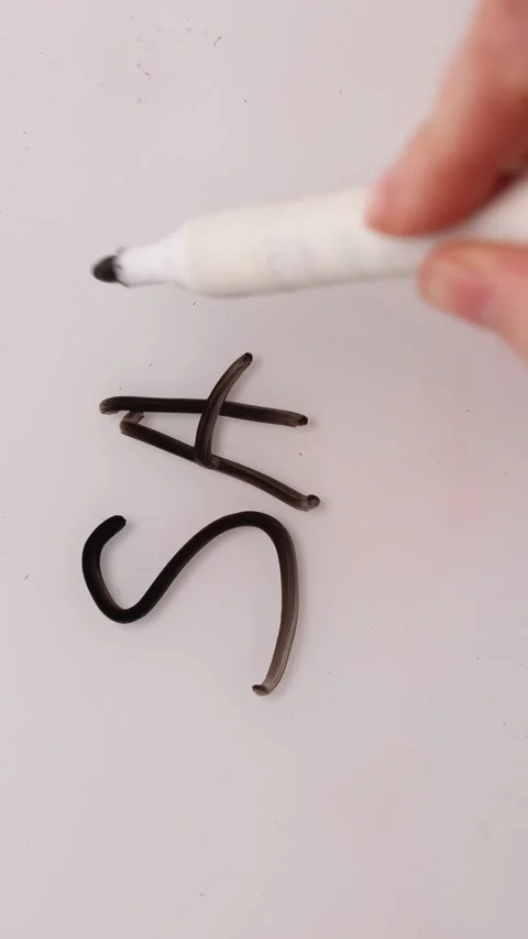 Hand Writes and Completes the Word Sale With a Black Marker on White Surface Stock Footage 324696507