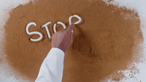 Hand writes on brown soil words Stop hunger Stock Footage 248676926