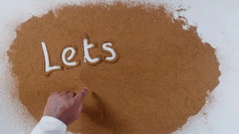 Hand writes on brown soil words Let's cook Stock Footage 248679943