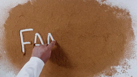 Hand writes on brown soil words Famine Stock Footage 248680563