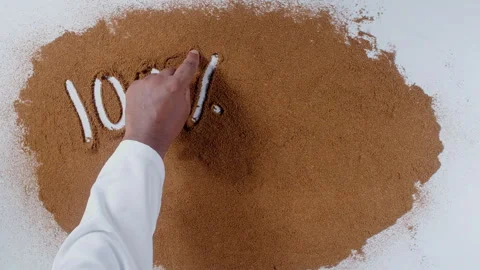 Hand writes on brown soil words 100% natural Stock Footage 248682452