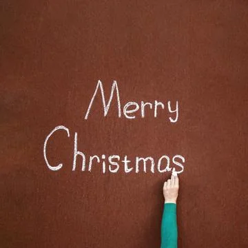 Hand writes with chalk on an abstract surface Merry Christmas, written in c.. Stock Photos