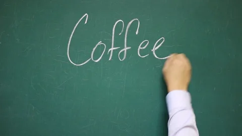 Hand writes COFFEE on a school blackboard Vídeos de archivo 123673936