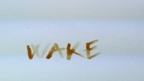 Hand writes with coffee, the word wake up Video stock 87776023