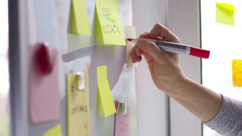Hand writes down note post on sticker. Brainstorm. Business idea concept. 4K. Stock Footage 154355916