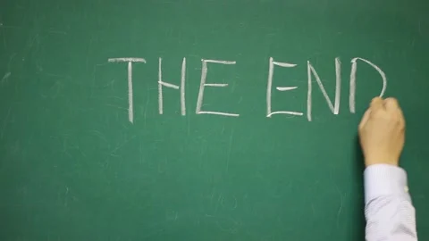 Hand writes THE END on a blackboard Video stock 133011775