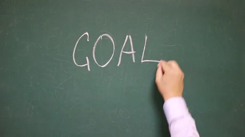 Hand writes GOAL on a blackboard Stock Footage 123723434