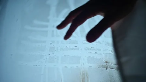 Hand writes  lines stripes  on window glass with drops background Stock Footage 153432819