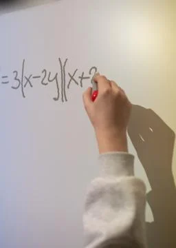 Hand writes a mathematical equation on a multimedia whiteboard Stock Photos