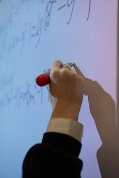 Hand writes a mathematical equation on a multimedia whiteboard Stock Photos