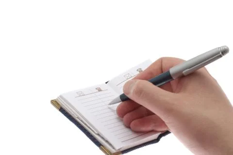 Hand writes in a notebook Stock Photos