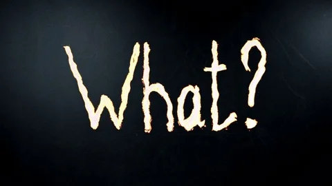 Hand writes question what by chalk on a blackboard. Written is heated. Timelapse Stock Footage 76048587