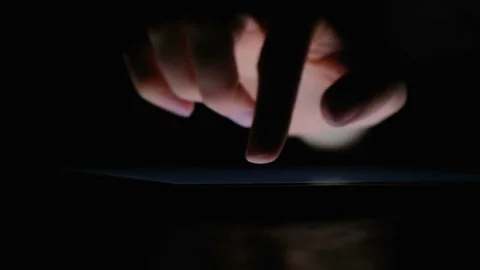 Hand writes on the tablet with your finger in the dark close up, 4k. Stock Footage 84636528