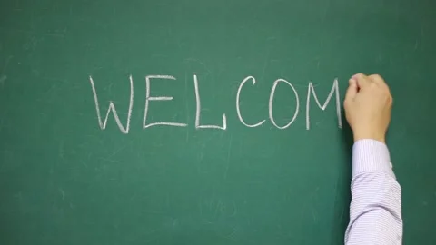 Hand writes WELCOME on a blackboard Video stock 133011829