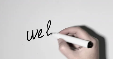 Hand writes WELCOME on a whiteboard Stock Footage 145179639