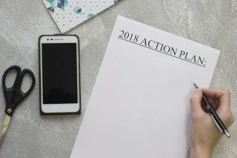 Hand writing 2018 action plan, mobile phone, scissors Stock Photos