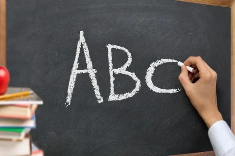Hand writing ABC on classroom blackboard Stock-Fotos