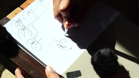 Hand writing abstract cursive lines on paper with pen, close up Stock Footage 329479816