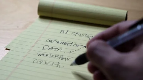 Hand writing AI strategy checklist on yellow notepad Video stock 336643801
