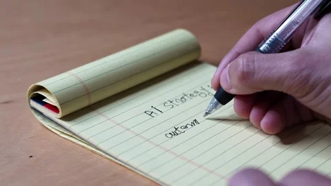 Hand writing AI strategy on yellow notepad Stock Footage 337110927