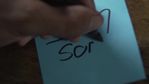 Hand writing an apology note with a broken heart Stock Footage 319344581