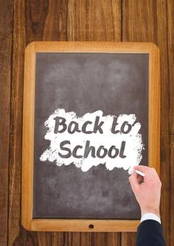 Hand writing back to school text on blackboard 스톡 사진