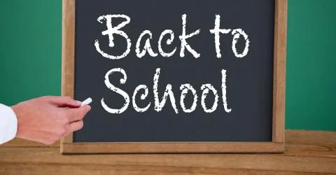Hand writing back to school text on blackboard Stock Photos