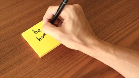 Hand Writing 'be happy' on Sticky Note Stock Footage 328331155