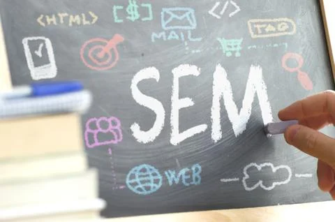 Hand writing on a blackboard in a SEM class with some icons and concepts Stock Photos