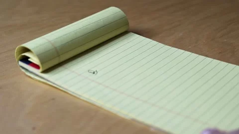 Hand writing business plan on yellow legal pad Stock Footage 337135490
