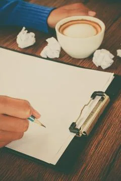 Hand writing with cup of coffee Stock Photos