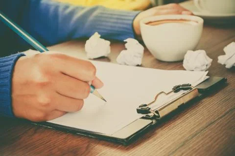 Hand writing with cup of coffee Stock Photos