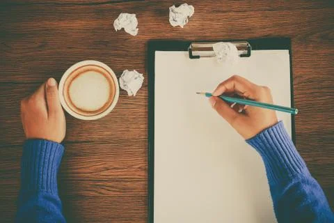 Hand writing with cup of coffee Stock Photos
