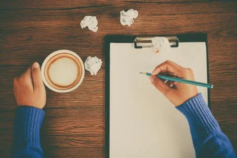 Hand writing with cup of coffee Stock Photos