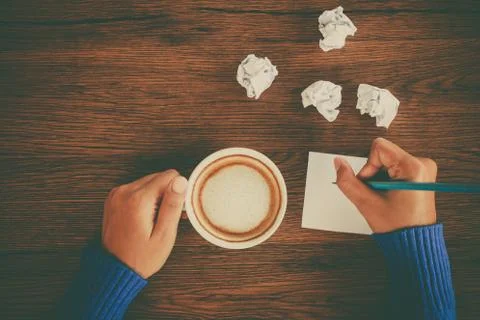 Hand writing with cup of coffee Stock Photos